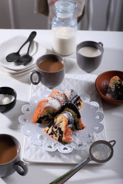 istock Marble Cake with Coffee with Powder Sugar and Kitchen Vintage Utensil, White Bakery Concept 1900923042