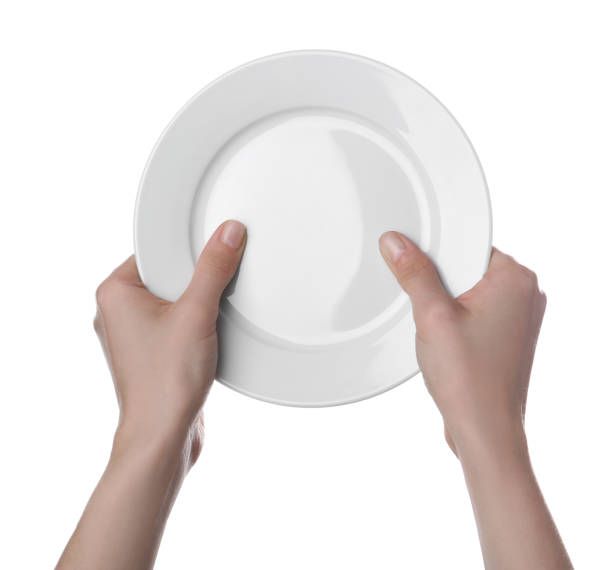 istock Woman holding clean ceramic plate isolated on white, closeup 1900985757
