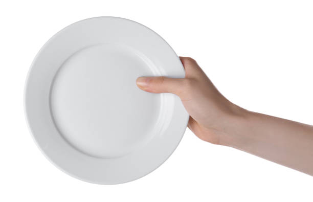 istock Woman holding clean ceramic plate isolated on white, closeup 1900986157