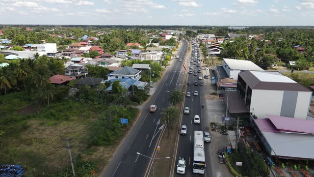 Bird's eye view of Traffic jams on the highway during the New Year Festival 1 JANUARY 2024,Nangrong Buriram,Thailand from the drone.
