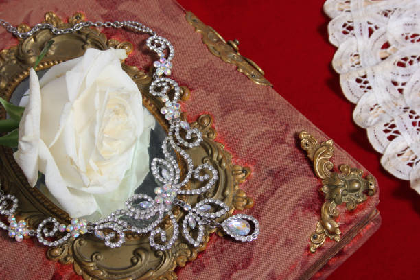 istock White Rose on Antique Book With Crystal Rhinestone Necklace 1901040418