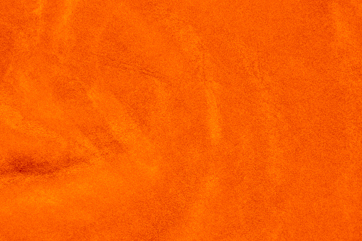 light orange velvet fabric texture used as background. silk color saffron fabric background of soft and smooth textile material. crushed velvet .luxury sun light tone for silk.
