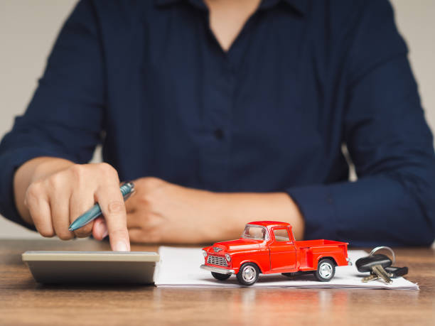 istock Car loan, Auto loan, or Title loan. Businessman using a calculator while sitting at the table 1901076826