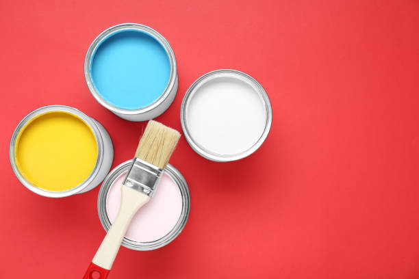 istock Cans of different paints and brush on red background, flat lay. Space for text 1901092209
