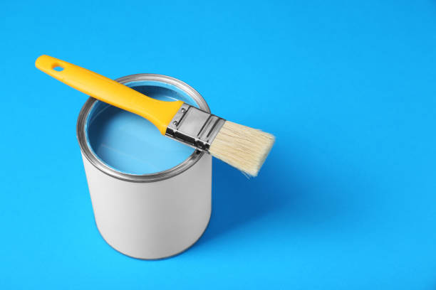 istock Can of paint with brush on light blue background, space for text 1901092330