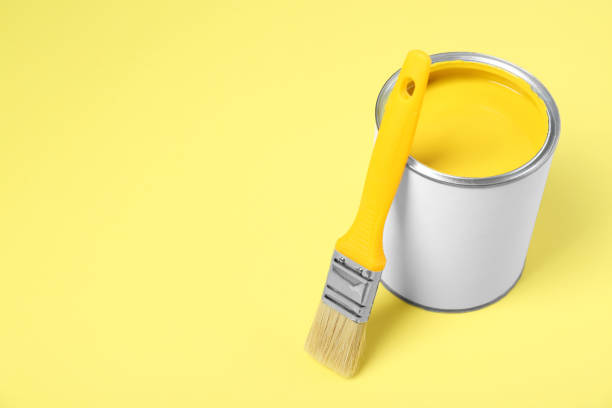 istock Can of paint and brush on pale yellow background. Space for text 1901093254