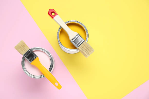 istock Cans of different paints with brushes on color background, flat lay. Space for text 1901093762