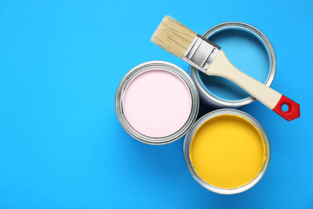 istock Cans of colorful paints and brush on light blue background, flat lay. Space for text 1901094292