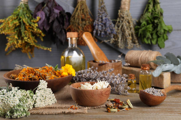 istock Many different dry herbs on wooden table 1901104734