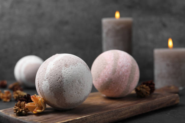 istock Bath bombs, candles and dry flowers on black table, closeup 1901105656