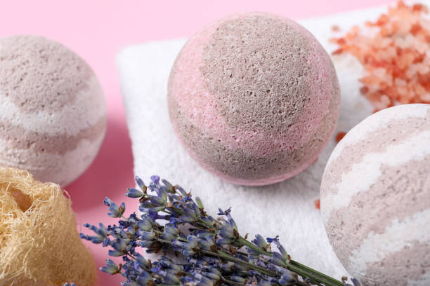 istock Bath bombs, towel, lavender and loofah sponge on pink background, closeup 1901105659