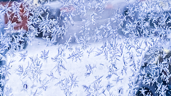 As temperatures drop beautiful ice crystals form on a cold mirrored surface.