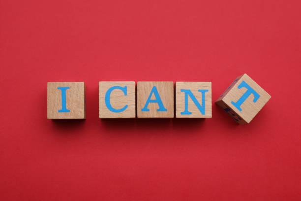istock Motivation concept. Changing phrase from I Can't into I Can by removing wooden cube with letter T on red background, flat lay 1901124617