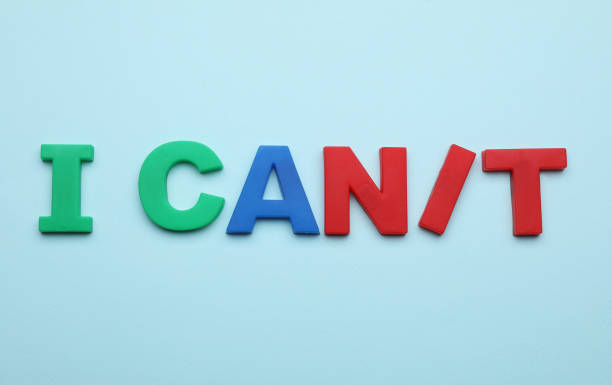 istock Motivation concept. Changing phrase from I Can't into I Can by adding slash symbol on light blue background, flat lay 1901124620