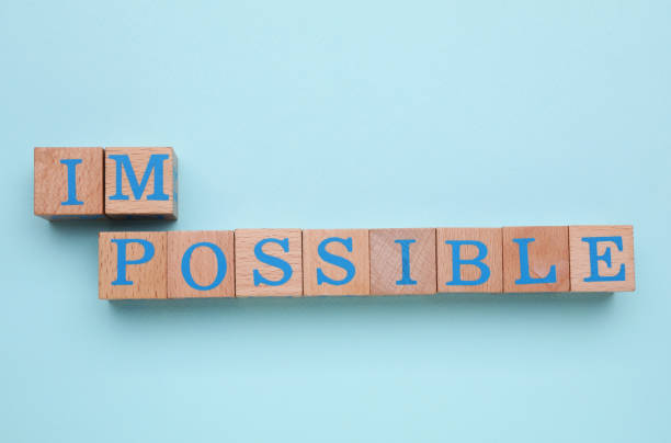 istock Motivation concept. Changing word from Impossible into Possible by removing wooden cubes on light blue background, flat lay 1901124626