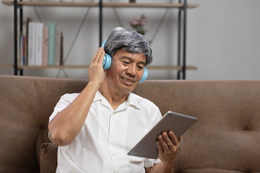 Music therapy in dementia treatment on asian senior man.