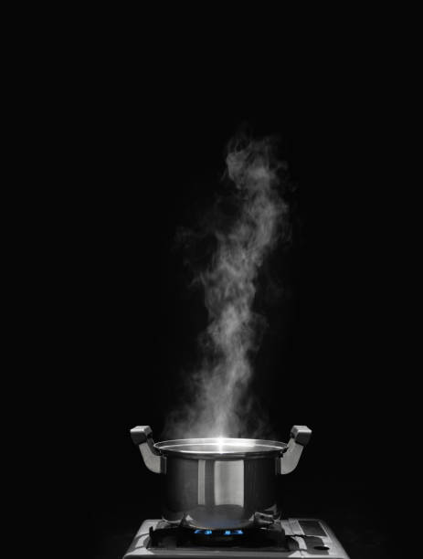istock steam over cooking pot in kitchen on dark background. 1901152077