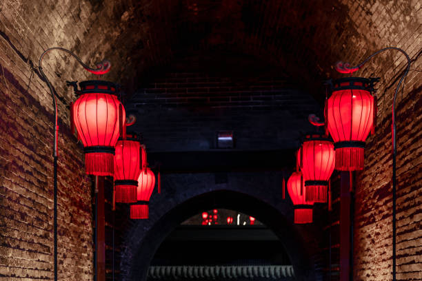 istock Neat red lanterns stand beside the ancient Chinese city wall 1901159160