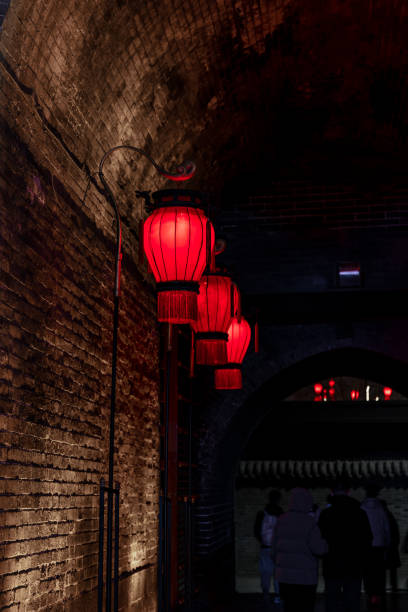 istock Neat red lanterns stand beside the ancient Chinese city wall 1901159667