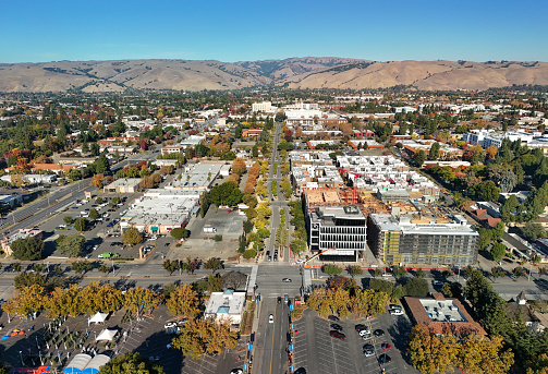 Aerial view of central Fremont during Autumn, featuring new housing construction and beautiful trees, with Capitol Avenue in the center and the Diablo Range in the background.