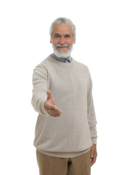 istock Senior man welcoming and offering handshake isolated on white 1901200742
