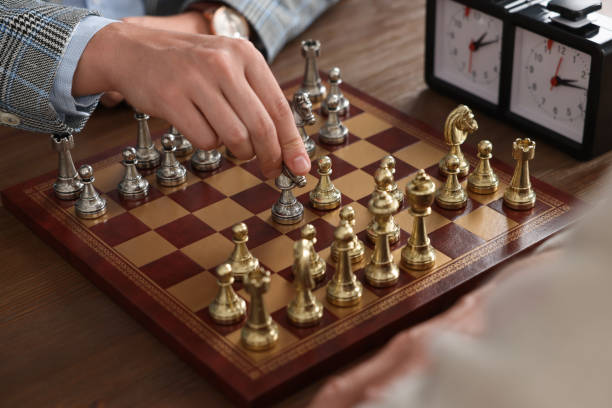 istock Men playing chess during tournament at wooden table, closeup 1901219158