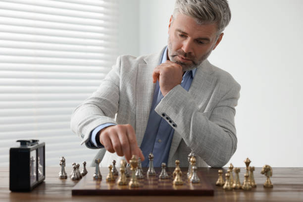istock Man playing chess during tournament at table indoors 1901221254