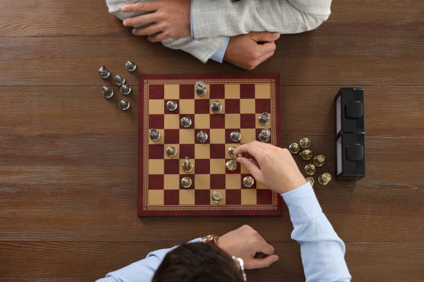 istock Men playing chess during tournament at wooden table, top view 1901222826
