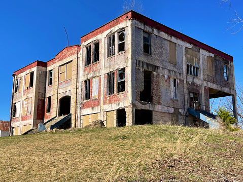 Exterior of old decayed abandoned prison in Kolyma in evening light