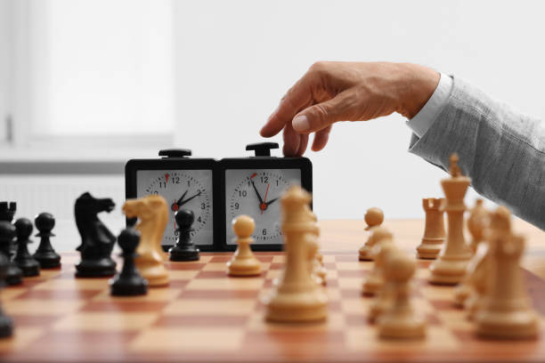 istock Man turning on chess clock during tournament at chessboard, closeup 1901254580