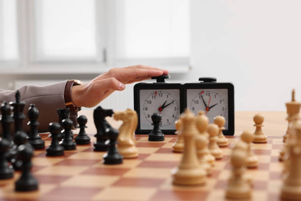 istock Man turning on chess clock during tournament at chessboard, closeup 1901256145