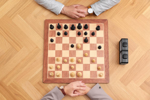 istock Men playing chess during tournament at wooden table, top view 1901259707