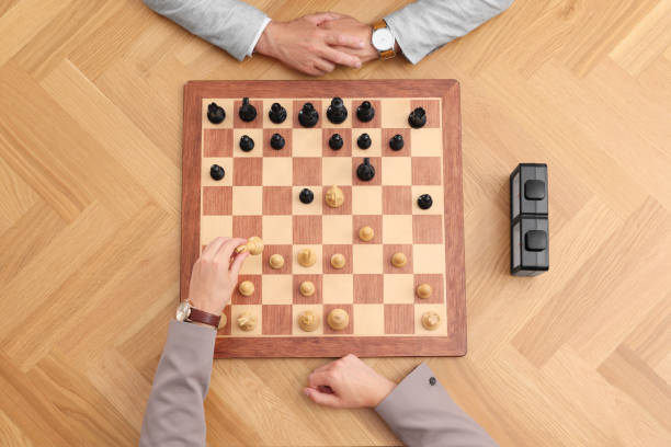 istock Men playing chess during tournament at wooden table, top view 1901259708