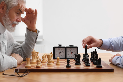 elder stress seriously thinking while playing chess board game