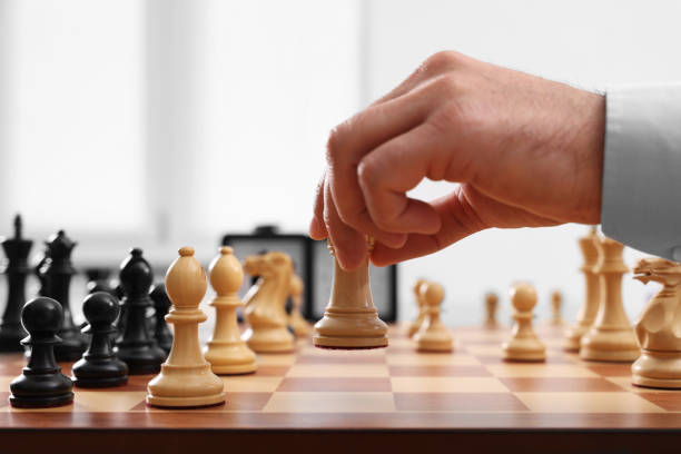 istock Man playing chess during tournament at chessboard, closeup 1901261238