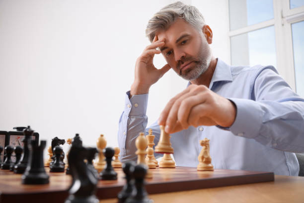 istock Man playing chess during tournament at table indoors 1901264303