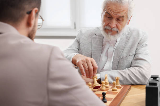 istock Men playing chess during tournament at table indoors 1901265319