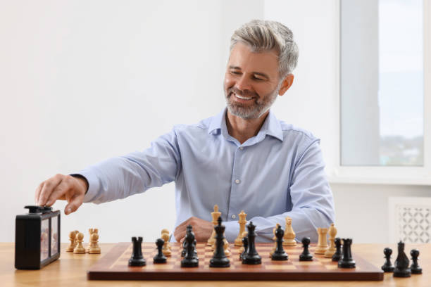 istock Man turning on chess clock during tournament at table indoors 1901266359