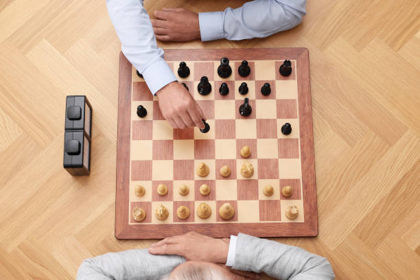 istock Men playing chess during tournament at wooden table, top view 1901266886