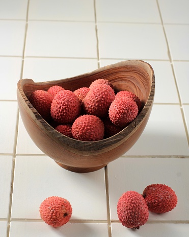 Litchi, Lichee, Lychee, or Lichi, Fresh Lychess Fruit on Wooden Bowl and  White Background, Isolated, Selective Focus Picture.