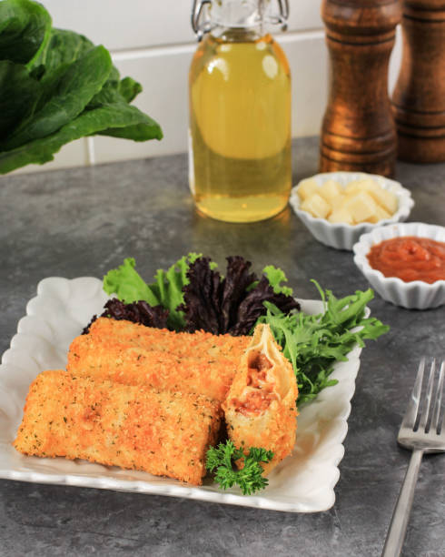 Fried Risoles or Risol Vegetable with Minced Meat Lasagna Sauce. Served with Chili Sauce and Mayonaise, Garnish with Fresh Parsley.