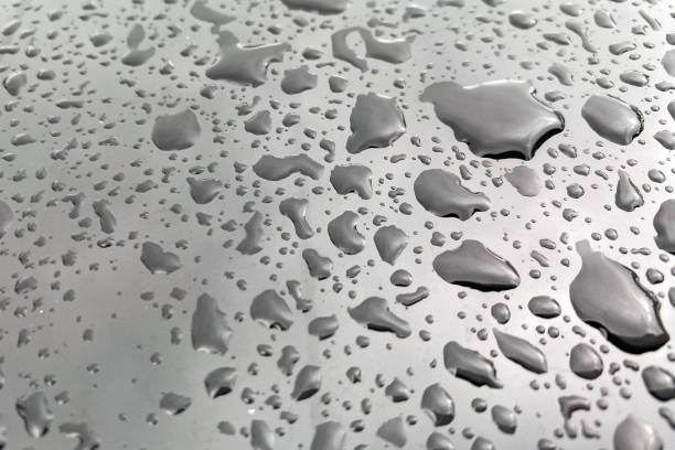 istock Large drops of water on a black glossy surface 1901337819