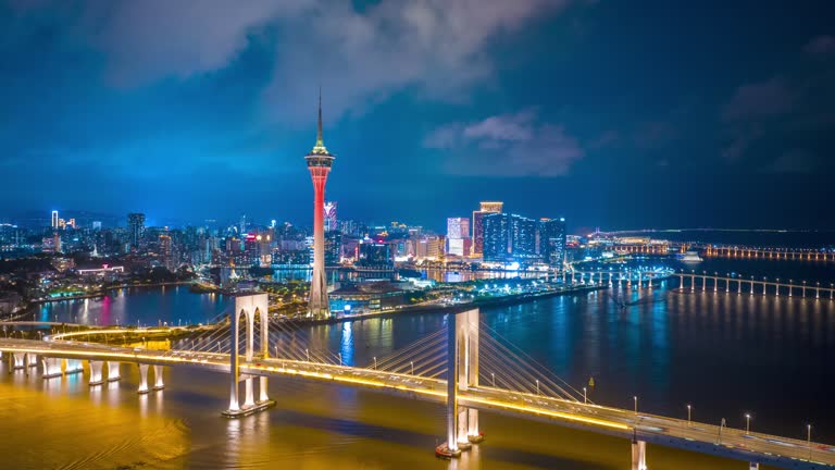 Macau cityscape skyline with hotel and casino skyscraper over neon at night.