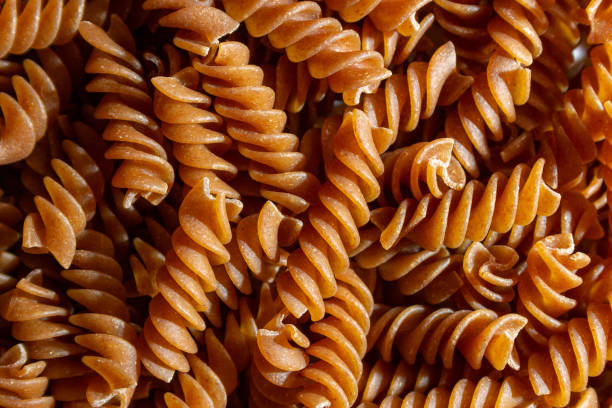 istock Uncooked Whole Grain Fusilli Pasta Background 1901377609