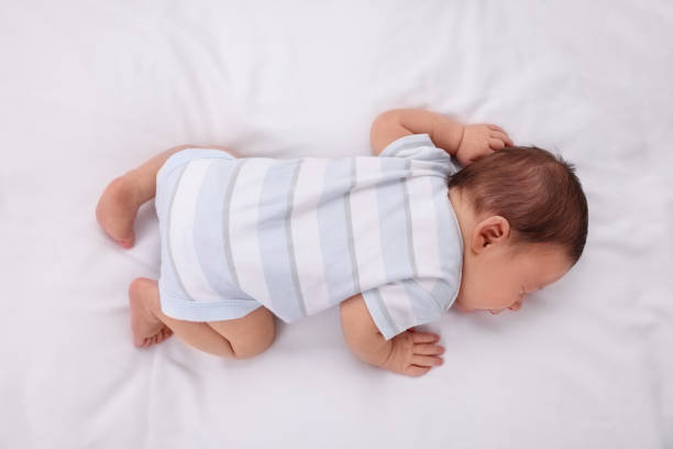istock Cute newborn baby sleeping in crib, top view. Bedtime 1901383289
