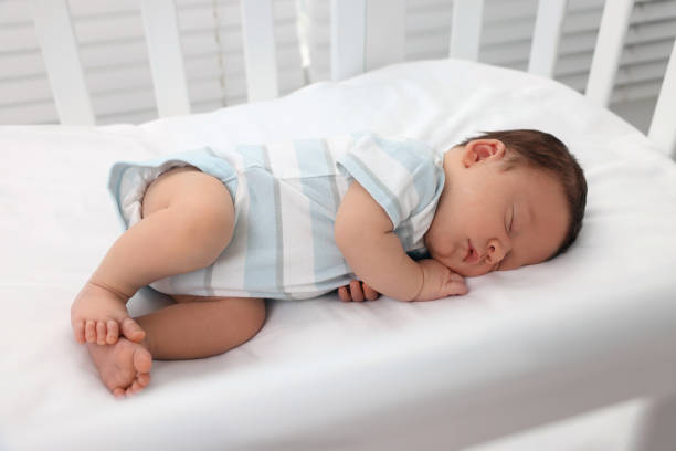 istock Cute newborn baby sleeping in crib. Bedtime 1901383810