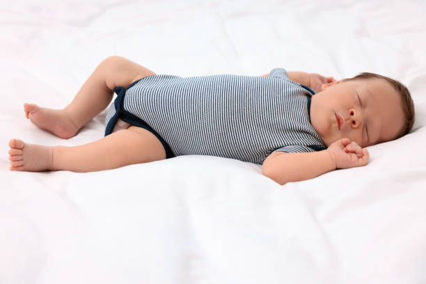 istock Cute newborn baby sleeping on white soft bed 1901384343