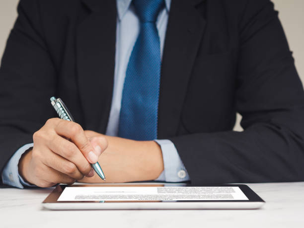 istock Businessman signature electronic contract on a digital tablet while sitting at the table. 1901386428