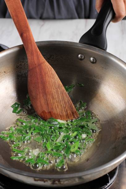istock Selected Focus Sautee or Stir Fry Spring Onion in a Pan, Cooking Step by Step in the Kitchen Making Asian or Korean Food 1901395220