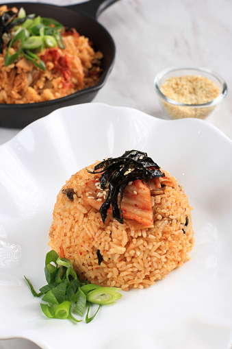 Korean Food: Bokkeumbap or Kimchi Fried Rice, South Korea Traditional Recipe Fried Rice with Kimchi, Spring Onion, Sesame Seed, Tomato, and Nori (Laver)